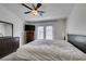 Primary bedroom with a fan, TV, dresser, and access to a private balcony at 2787 Fountain Ridge Ln, Henderson, NV 89074