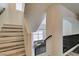 Bright staircase featuring wood-look steps, black railings, and a view to the living area below at 2787 Fountain Ridge Ln, Henderson, NV 89074