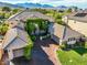 Stunning aerial view of a two-story home with a three-car garage, lush landscaping, and a mountain view at 3041 Hammerwood Dr, Las Vegas, NV 89135