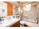 Bathroom featuring a shower-tub combo with glass doors and bright orange accents at 3041 Hammerwood Dr, Las Vegas, NV 89135