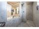 A walk-in shower with floor-to-ceiling marble tiles and an adjacent soaking tub at 3041 Hammerwood Dr, Las Vegas, NV 89135