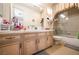 Bathroom features white cabinetry, dual sinks, large mirror and combined tub with shower at 3041 Hammerwood Dr, Las Vegas, NV 89135