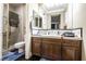 Bathroom features a white shower and a wood vanity with lots of storage at 3041 Hammerwood Dr, Las Vegas, NV 89135