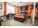 Cozy bedroom with vibrant orange walls and ample natural light at 3041 Hammerwood Dr, Las Vegas, NV 89135