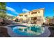 Backyard features a sparkling pool, spa, lush landscaping, and relaxing lounge areas at 3041 Hammerwood Dr, Las Vegas, NV 89135