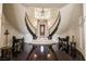 Elegant foyer showcasing a curved staircase, chandelier, and hardwood floors at 3041 Hammerwood Dr, Las Vegas, NV 89135