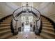 Grand foyer with a curved staircase, chandelier, and hardwood floors at 3041 Hammerwood Dr, Las Vegas, NV 89135