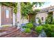 Inviting front entrance with a stone pillar, greenery, and a decorative walkway at 3041 Hammerwood Dr, Las Vegas, NV 89135