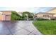 Beautiful exterior with a stamped concrete driveway, 3-car garage and lush ivy at 3041 Hammerwood Dr, Las Vegas, NV 89135