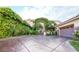 Stunning home with lush ivy covering the exterior and a stamped concrete driveway at 3041 Hammerwood Dr, Las Vegas, NV 89135