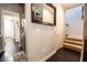 Hallway with hardwood floors, access to the staircase, and a view of the laundry room at 3041 Hammerwood Dr, Las Vegas, NV 89135