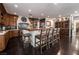 Large open kitchen with wood cabinetry, oversized island, and counter seating at 3041 Hammerwood Dr, Las Vegas, NV 89135