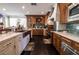 Spacious kitchen featuring custom wood cabinetry, stainless steel appliances, and beautiful tile backsplash at 3041 Hammerwood Dr, Las Vegas, NV 89135