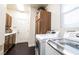 Well-equipped laundry room with modern washer and dryer units and ample storage at 3041 Hammerwood Dr, Las Vegas, NV 89135