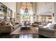 Elegant living room with soaring ceilings, hardwood floors, custom bookshelves, and access to the outdoor space at 3041 Hammerwood Dr, Las Vegas, NV 89135