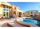 Resort style backyard with a large pool, jacuzzi, sauna, and cozy seating at 3041 Hammerwood Dr, Las Vegas, NV 89135