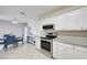 Bright kitchen with stainless appliances, and dining area with tiled floor at 3151 Soaring Gulls Dr # 1192, Las Vegas, NV 89128