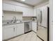 Corner kitchen featuring stainless steel appliances, white cabinets, and stone countertops at 3151 Soaring Gulls Dr # 1192, Las Vegas, NV 89128