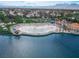 Breathtaking view of a lake with sandy beach and homes, set against a mountain backdrop, ideal for recreation at 3151 Soaring Gulls Dr # 1192, Las Vegas, NV 89128