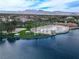 Scenic view of a lake with a sandy beach area and lush greenery surrounded by houses with a mountain backdrop at 3151 Soaring Gulls Dr # 1192, Las Vegas, NV 89128