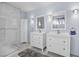 Updated bathroom with double sinks, mirrors, vanity, and a glass-enclosed shower at 367 Lander Dr, Henderson, NV 89074