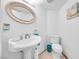 Bathroom features a white pedestal sink, toilet, and a framed mirror at 367 Lander Dr, Henderson, NV 89074