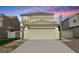 Two-story home featuring a beige exterior, two-car garage, and desert landscaping at 367 Lander Dr, Henderson, NV 89074