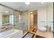 Bright bathroom with a glass shower enclosure, soaking tub, double sink vanity, and modern fixtures at 3722 Las Vegas Blvd # 1908, Las Vegas, NV 89158