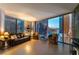 Elegant living room with floor-to-ceiling windows, city views, and stylish seating arrangement at 3722 Las Vegas Blvd # 1908, Las Vegas, NV 89158