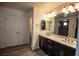 Bathroom with dual sinks, a large mirror, and modern vanity at 386 Espressivo St, Henderson, NV 89011