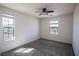 Well-lit bedroom with carpet, ceiling fan and two windows allowing natural light at 386 Espressivo St, Henderson, NV 89011