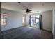 Bright bedroom with large windows, ceiling fan, and neutral carpet at 386 Espressivo St, Henderson, NV 89011