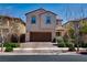 Two-story stucco house with brick driveway and two-car garage at 386 Espressivo St, Henderson, NV 89011