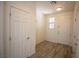Hallway with wood tile floors, white doors, and natural light at 386 Espressivo St, Henderson, NV 89011