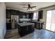 Modern kitchen with stainless steel appliances, dark cabinetry, and island at 386 Espressivo St, Henderson, NV 89011