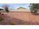 A spacious backyard with a brick paver patio, gravel landscaping, and mature trees at 3938 E Chaffe Ave, Pahrump, NV 89061
