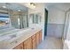Bright bathroom featuring double sinks, granite countertops and a glass shower at 3938 E Chaffe Ave, Pahrump, NV 89061