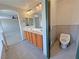 Bright bathroom featuring double sinks and a tiled floor at 3938 E Chaffe Ave, Pahrump, NV 89061