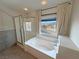 Bright bathroom featuring a soaking tub and glass shower at 3938 E Chaffe Ave, Pahrump, NV 89061