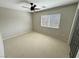 A carpeted bedroom featuring a window with blinds, a ceiling fan, and neutral paint at 3938 E Chaffe Ave, Pahrump, NV 89061