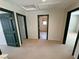 A carpeted bedroom featuring three doorways and two skylights for ample natural light at 3938 E Chaffe Ave, Pahrump, NV 89061