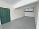 Clean garage with epoxy flooring, access door, and overhead storage at 3938 E Chaffe Ave, Pahrump, NV 89061