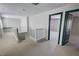 Upstairs hallway featuring neutral carpet, white railing, and access to multiple rooms at 3938 E Chaffe Ave, Pahrump, NV 89061