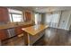 A modern kitchen features light wood cabinets, stainless appliances, granite countertops, and island with seating at 3938 E Chaffe Ave, Pahrump, NV 89061