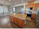 Open concept kitchen with stainless steel appliances, granite counters, large island, and hardwood floors at 3938 E Chaffe Ave, Pahrump, NV 89061