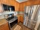 Modern kitchen features stainless steel appliances, granite countertops, and wooden cabinets at 3938 E Chaffe Ave, Pahrump, NV 89061