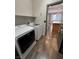 A laundry room with modern machines and an adjacent living space beyond a painted door at 3938 E Chaffe Ave, Pahrump, NV 89061