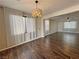Spacious living room with wood floors, a chandelier, and natural light at 3938 E Chaffe Ave, Pahrump, NV 89061
