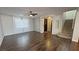Open-concept living room with wood flooring, a ceiling fan, and staircase at 3938 E Chaffe Ave, Pahrump, NV 89061