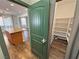 View of a kitchen island and a pantry with shelving and a green door at 3938 E Chaffe Ave, Pahrump, NV 89061